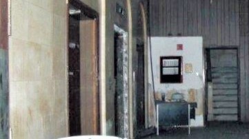 Before: view of unrestored lobby and enclosed stairs
